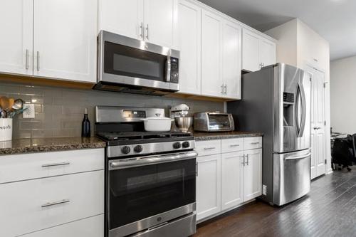 Modern kitchen featuring new stainless steel appliances Modern kitchen featuring new stainless steel appliances